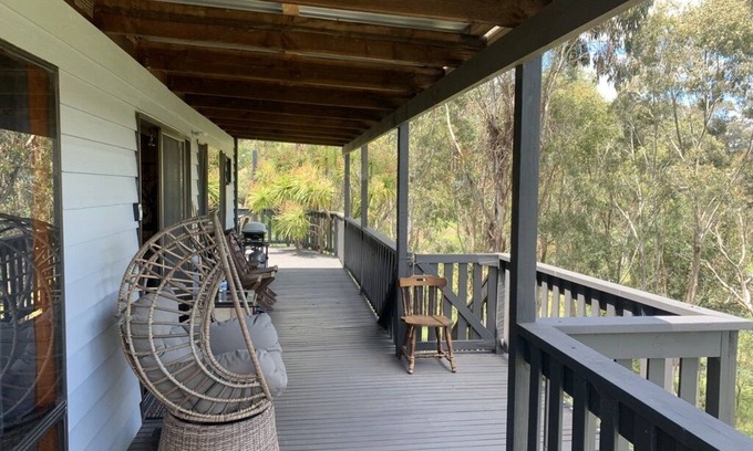 Goughs Bay Cabin | Rustic log cabin perched high on Goughs Bay