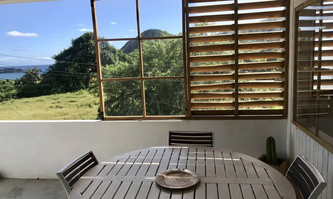 Falmouth House | Sea view apartment with endless breeze, lush garden.nature and animals lovers