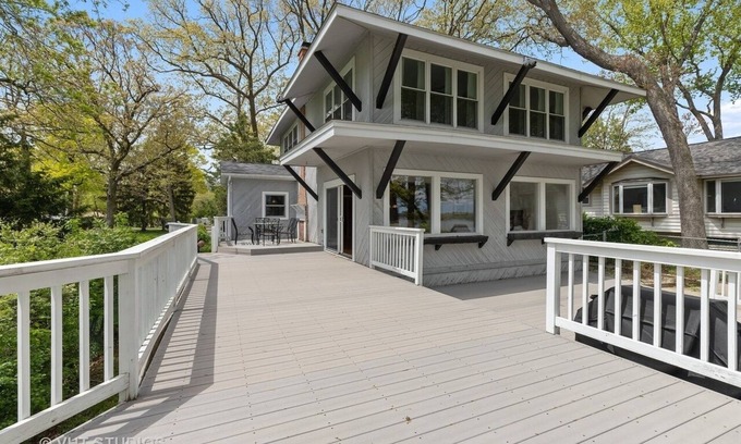 Channel Lake House | Serene lakefront house with expansive deck and pier