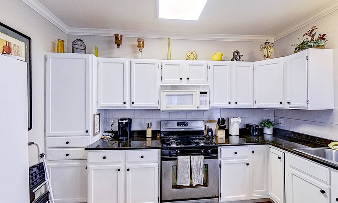 Midtown House | Spacious home with yard, deck, W/D, on-site parking & central AC