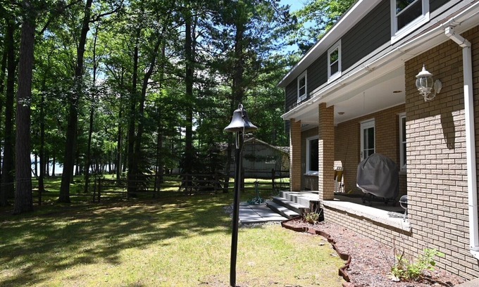 Hubbard Lake House | Spacious vacation home on large private wooded lot on crystal clear Hubbard Lake