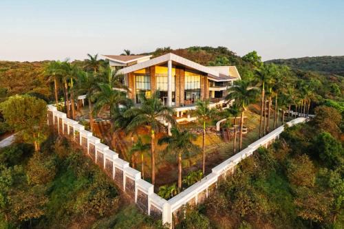Lonavala Villa | StayVista's Emerald Acres offering a heated pool, bonfire, snooker table, scenic views, tennis court, steam room, gazebo, & gym