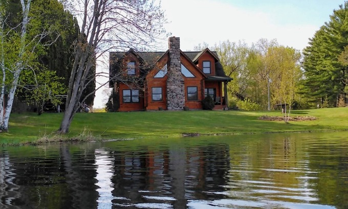 Grantsburg Cabin | Stunning log home with a rental pontoon on a quiet sunlit bay. Check it out!