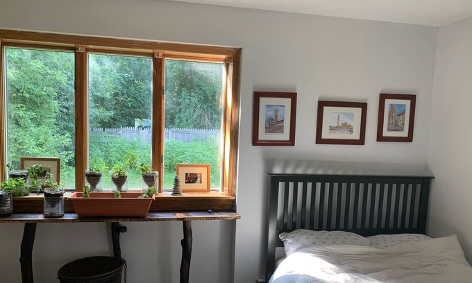Waddington House | Sunny bedroom with full bed and private bathroom.