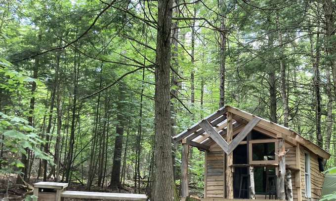 Freedom RV Rental | Tentrr Signature Site - Ohana Roots Camp at Sandy Pond, Forest Hideaway Site