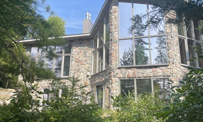 Puposky Cottage | The newly remodeled Stone Cabin with sandy beach and clean clear water