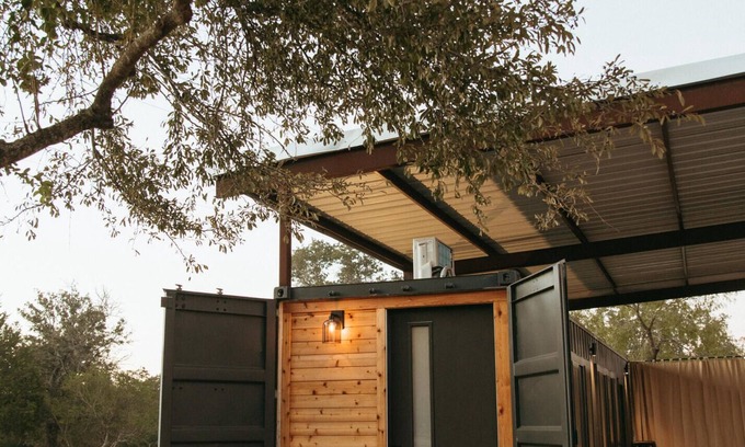 Prairie Lea RV Rental | This home sits on a 45 acre, wooded retreat and event venue called Wild Roots Lockhart with tons of amenities including pickleball!