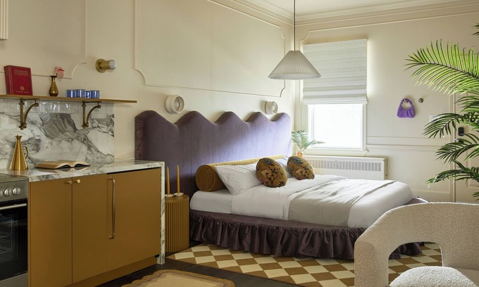 Stratford Hotel | This neutral flat packs a punch with a unique and interesting feature—a round king size bed!