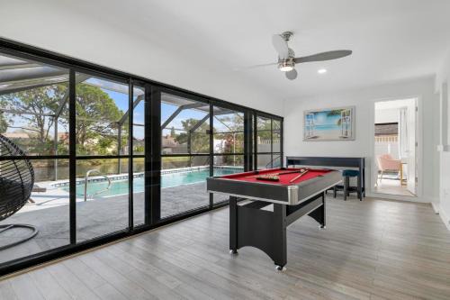 Palma Sola House | Tropical Tranquility! Luxury pool home with lakefront view just minutes from the beach!