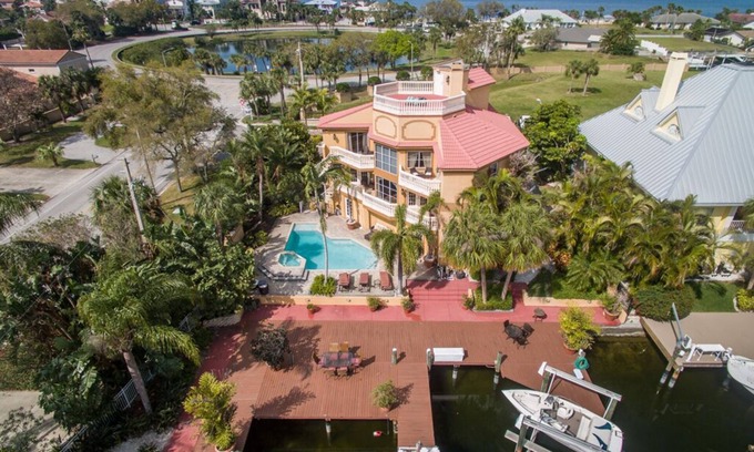 Gulf Harbors House | Tropical Waterfront Resort Home with Marina, Kayaks, Piano, Game Room