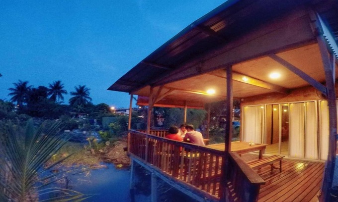 Ipoh House | Tung's Tropika - with a wooden hut by a lake