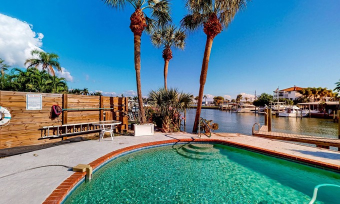 Capri Isle House | Two-story waterfront retreat with dock, pool, central AC, fireplace, & fast WiFi
