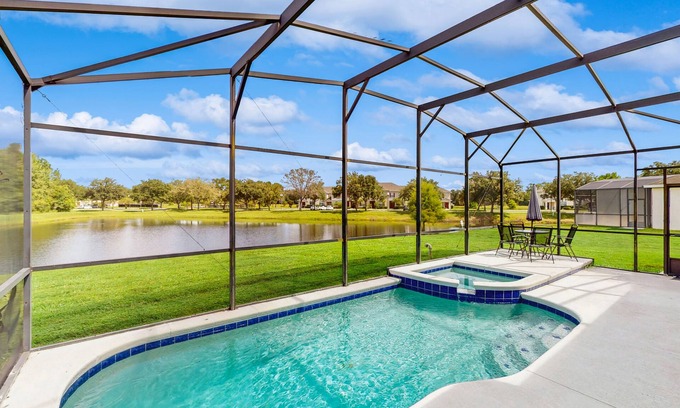 Trafalgar Village House | Water view retreat with lanai, heated pool, pool spa, game room, & AC