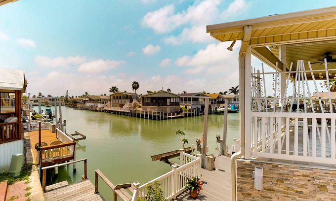 Port Isabel House | Waterfront home w/private dock & shared pools/hot tub/gym - 2 dogs welcome