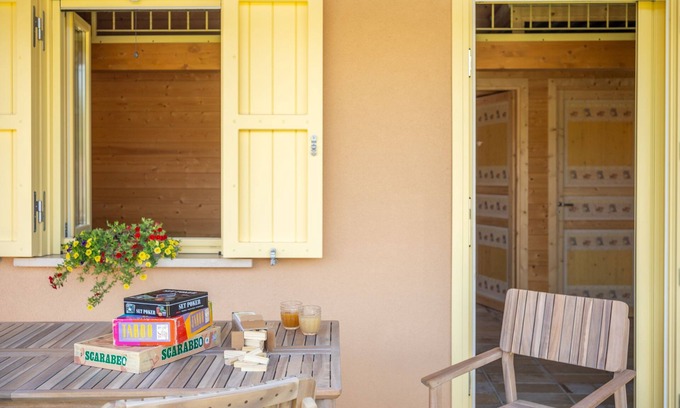 San Brizio Apartment | Wooden house with porch and garden
