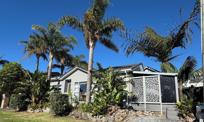 Browns Bay Cottage | Your coastal escape. Walk to the beach. Private spa, whole house access.
