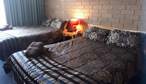 Room 29: Deluxe Twin Room (2 Queen Beds) with 50 inch Smart TV located on First Floor