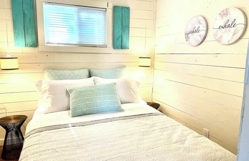 Whitewater Region Cottage | The Little Blue Beach House waterfront with shallow and sandy beach dog friendly