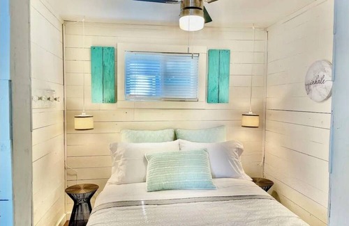 Whitewater Region Cottage | The Little Blue Beach House waterfront with shallow and sandy beach dog friendly