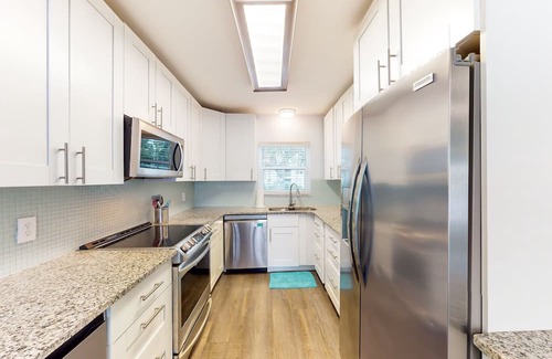 Capri Isle House | Renovated, waterfront townhome with pool & dock - walk to the beach