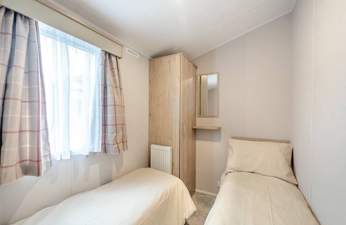 Sandyhills House | This spacious 2 bedroom caravan sleeps 4 people in one double and one twin bedroom.