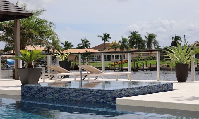 Caloosahatchee House | Custom Home with tile pool, boating dock and every comfort