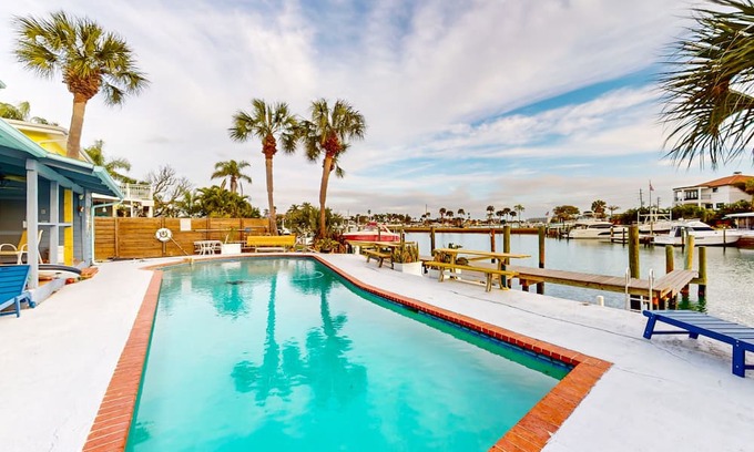 Capri Isle House | Renovated, waterfront townhome with pool & dock - walk to the beach