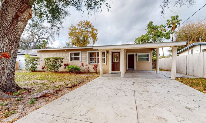 Carrollwood House | Lakefront home with private patio, waterfront sitting area, & W/D